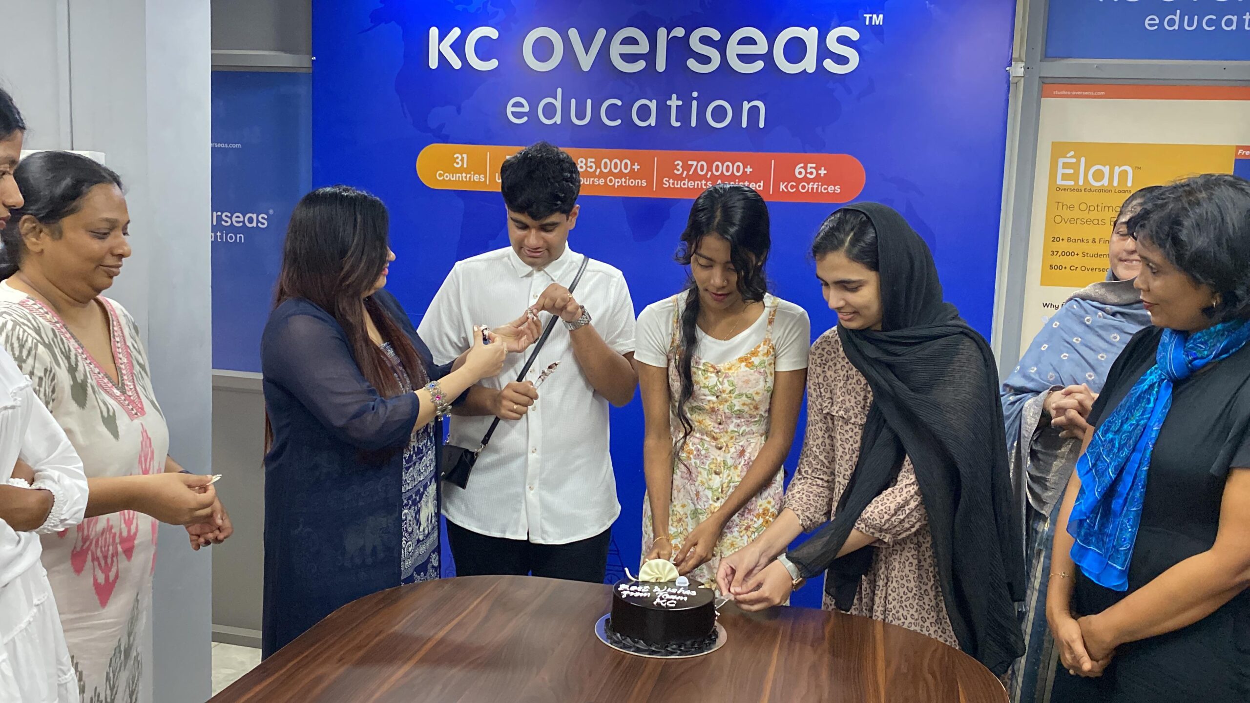 Students celebrating with the staff on receiving student visa at kc calicut