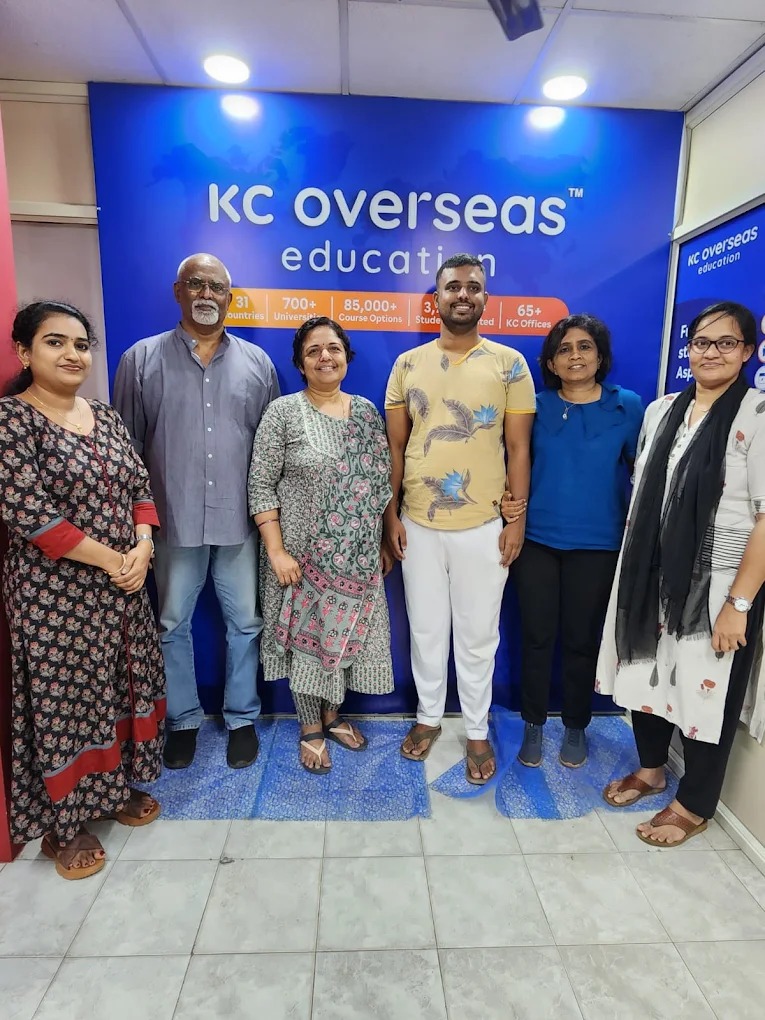 Picture of student with KC counselors and staff after receiving student visa