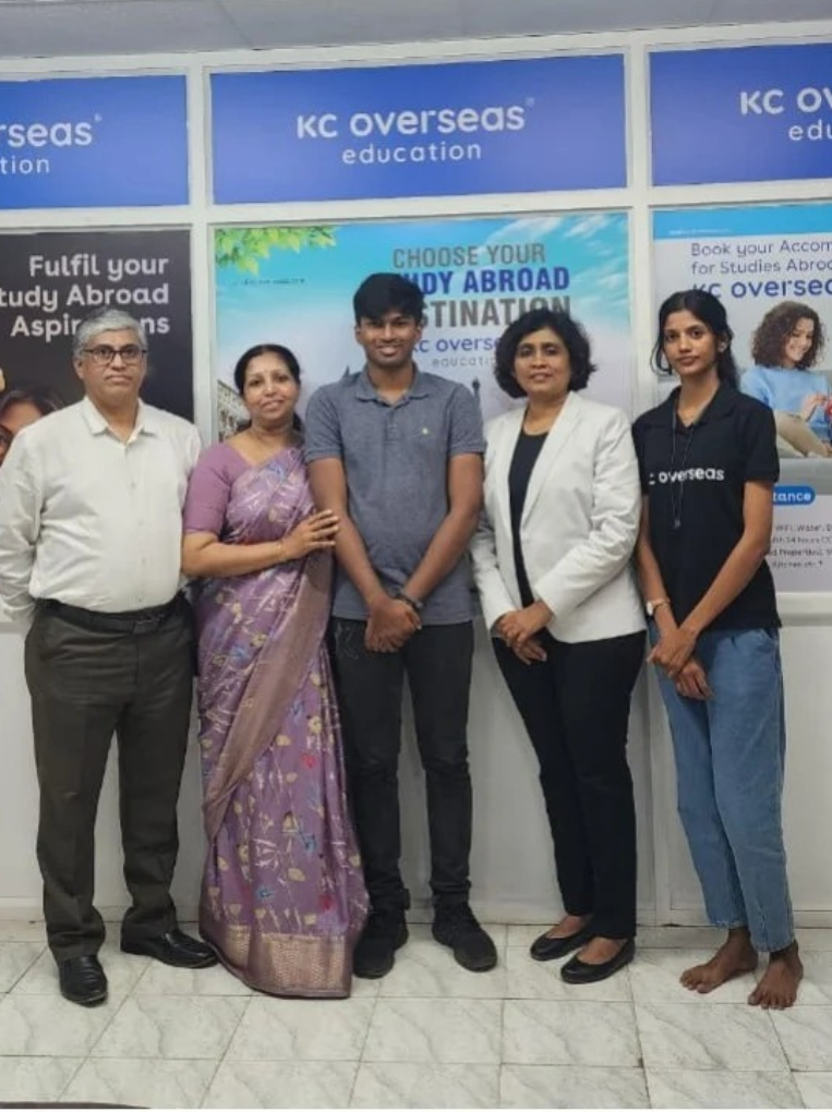 Picture of student with is family and the director after receiving visa