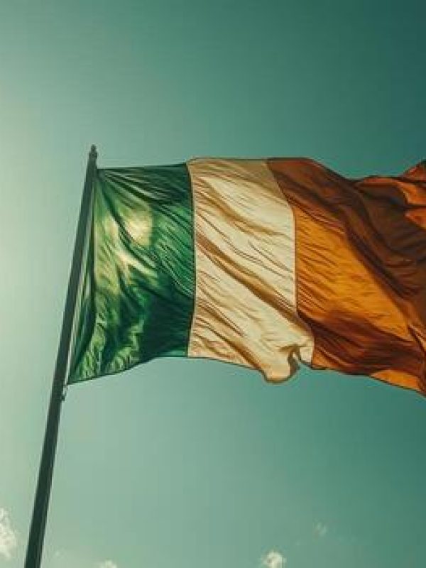 irish-flag-waving-in-wind-against-blue-sky-symbolizing-national-pride-and-celebration-photo